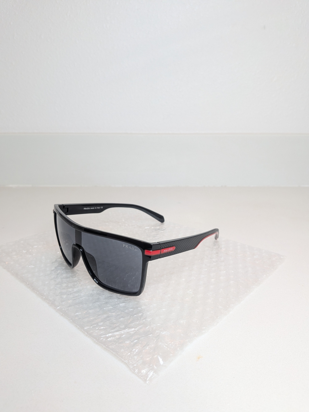 Prada Men’s Black Shield Sunglasses Red Logo Sport